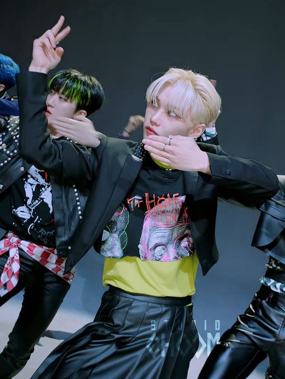 Lee Felix of Stray Kids wearing a Butthole Surfers t-shirt in the "MANIAC" music video